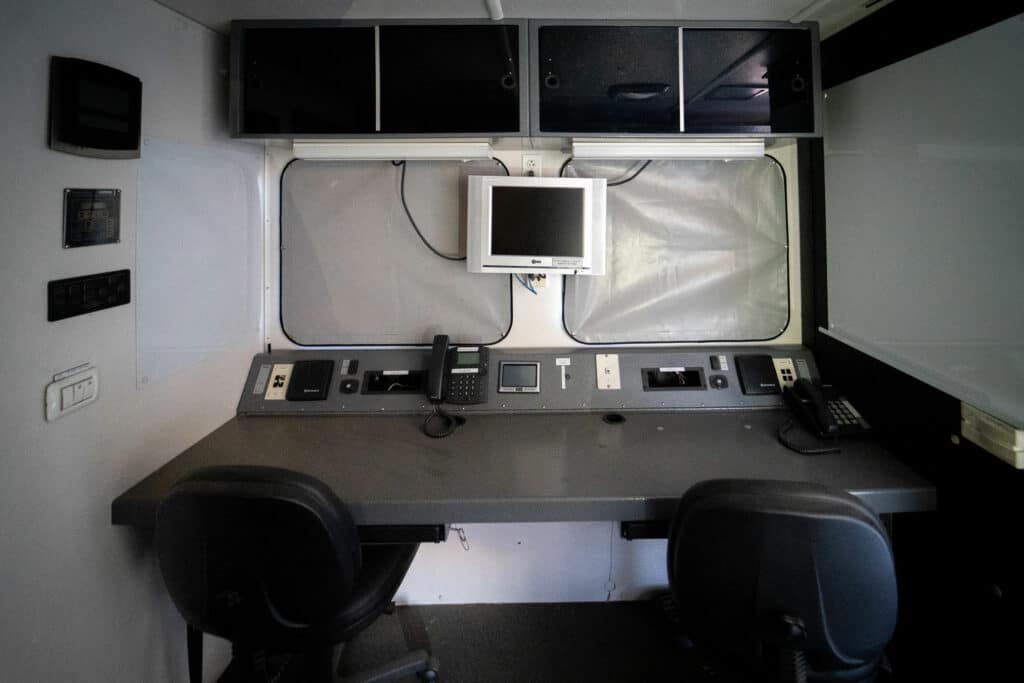 hazmat command center desk with chairs phones and monitor