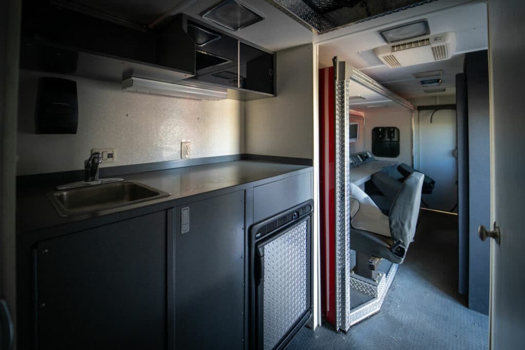 hazmat command center interior kitchenette with mini fridge and sink