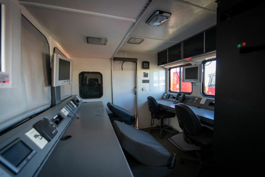 inside of hazmat command center with four chairs and two desk areas